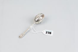 A tea infuser - an Edwardian white metal tea infuser with bamboo style handle