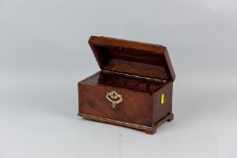 A Georgian mahogany tea caddy with brass carrying handle and escutcheon having three lidded tin