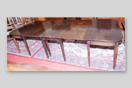 A Georgian mahogany twin D-end dining table with central three leaf gate leg, polished bull nose top