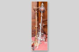 An Art Nouveau brass adjustable oil lamp stand along with a wrought iron and copper adjustable oil