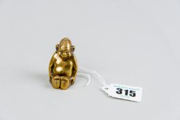 An unusual brass vesta case in the form of a seated monkey and bearing the stamped letters 'U S P,