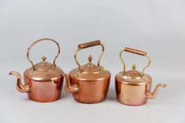 Two Georgian copper kettles and a Victorian brass and copper kettle, various sizes