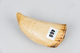 A scrimshaw decorated whale's tooth showing a worn depiction of a seafaring man, the words '
