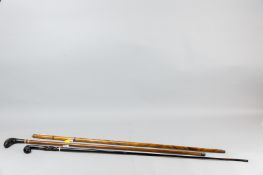 Three various walking canes, a multi-section wooden example (missing handle), one hickory shafted