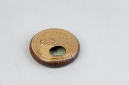 A circular wooden love token snuff box having a brass panel to the base of three figures entitled '