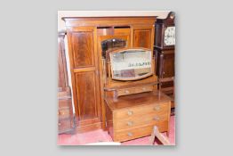 An Edwardian mahogany and inlaid triple wardrobe with central mirrored door and matching mirrored