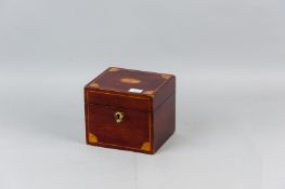 An Edwardian Sheraton style mahogany tea caddy with satinwood fan inlays and boxwood stringing,