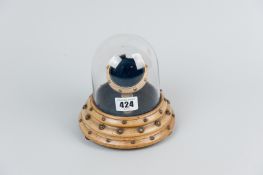 A Victorian oak pocket watch holder with glass dome cover, the turned wood base on bun feet set with