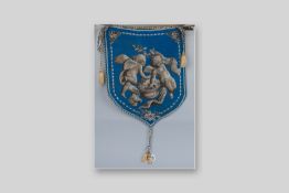 A Victorian shield shaped beadwork panel with rope edging and tasselled ends, the panel decorated