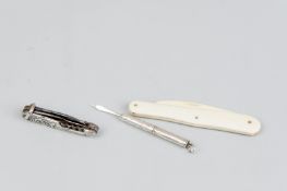 A decorative lady's believed silver backed penknife with tiny corkscrew, a retractable sterling