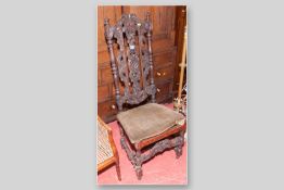 A carved oak Gothic style high back hall chair with an associated seat pad (cane work original, seat