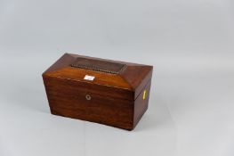 A 19th Century sarcophagus shaped walnut tea caddy on bun feet (one missing), the lift-up lid