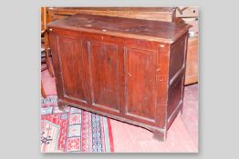 A Georgian pine lidded dower chest with triple panel front, twin panel sides on raised bracket feet,