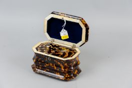 A 19th Century tortoiseshell and ivory sarcophagus shaped tea caddy with silver wire stringing,
