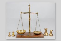 A set of Victorian brass beam scales by W & T Avery on a moulded edge mahogany base along with