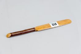 An Edwardian letter opener with satin wood blade and briar wood handle