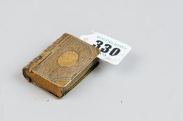 A brass vesta case/stamp box in the form of a book