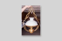A late Victorian hanging brass oil lamp with polished brass font and white shade, 27 x 18 ins (68.