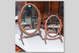 An Edwardian mahogany and line inlaid oval swing toilet mirror on shaped frame and raised supports