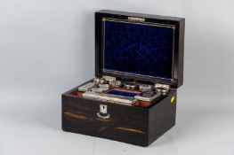 A Victorian Coromandel and ebony travelling toiletries box with mother of pearl cartouche and