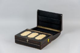 A Victorian Coromandel and brass edged triple hinged writing slope with brass inset carrying
