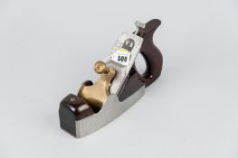 A coffin shaped steel smoothing plane with mahogany infill and handle, 10 ins (25.5 cms) in length