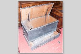 A 19th Century pine lidded chest with single drawer below and iron carry handles, interior candle