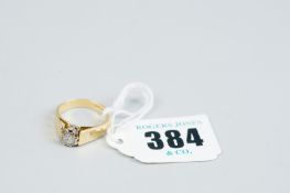 An eighteen carat gold diamond solitaire dress ring with starcut shoulders, 5.2 grms