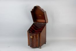 A Georgian mahogany knife box, serpentine fronted with crossbanded edges and central shell motif