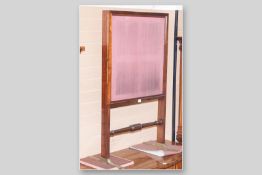 An early Victorian extending mahogany firescreen, twin slide-out panels with turned knobs and