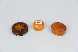 A circular fruit wood screw-on lidded container with interior glass dish, an oval line decorated