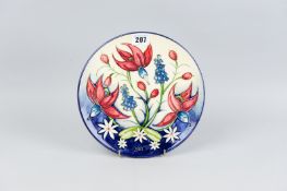 A Moorcroft pottery limited edition (4/750) 2001 year plate, cream and lilac ground body with '