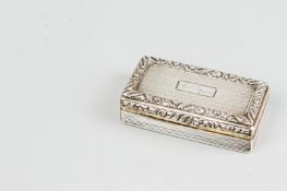 A snuff box - a heavy narrow oblong silver snuff box with gilt interior and having raised floral