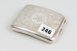 A card case - a slightly curved silver card case with all over scrolled decoration, 1.5 ozs,