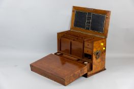 A mahogany and walnut veneered tabletop stationery cabinet with brass side carrying handles, the
