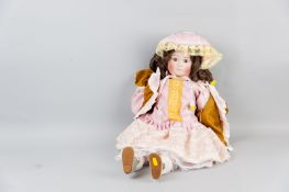 A Jumeau bisque headed doll with ringlet hair, fixed brown eyes and closed mouth, cloth body,