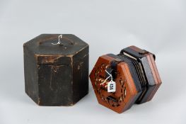 A Victorian squeezebox by Lachenal & Co, London, original paper label within the fretwork button