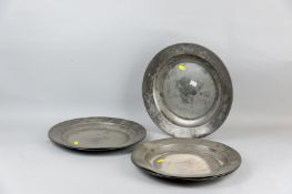 A set of six good sized pewter dished plates, all with folded rims and faint London marks, 14.75 ins