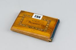 A small olive wood bound album marked 'Jerusalem' containing pressed flowers from the Holy Land