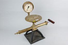 A vintage brass laboratory vacuum pump with cast metal bench plate marked 'Baird & Tatlock,