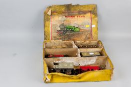 A Meccano Limited Hornby clockwork train, tinplate engine, carriage and goods wagons in original box
