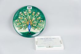 A Moorcroft pottery 1994 limited edition (132/500) year plate, a green ground plate decorated with a