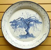 A large blue and white studio pottery stoneware dish, decorated with tree and landscape, unknown
