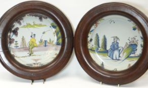 A pair of polychrome delft plates, painted in the Chinese taste with a figure each in landscapes,