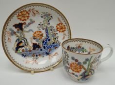 A nineteenth century English porcelain cup and saucer, decorated in the Indian-tree style with