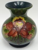 A Moorcroft green ground tube-lined floral onion-shaped vase, 3.5ins high (9cms)