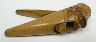 A Black Forest style wooden novelty nutcracker in the form of a gruesome carved figure in American