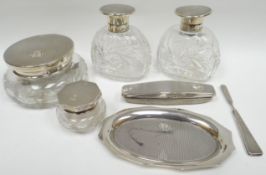 A seven piece silver and glass part dressing-table set including two jars, two bottles, small tray
