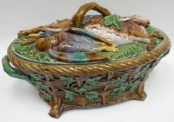 A Minton majolica game-pie dish, the cover decorated with dead game and twig-form handle, the body