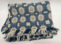 A blue and white patterned traditional Welsh blanket from Solva Woollen Mill